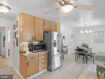 a kitchen with stainless steel appliances a refrigerator sink and cabinets