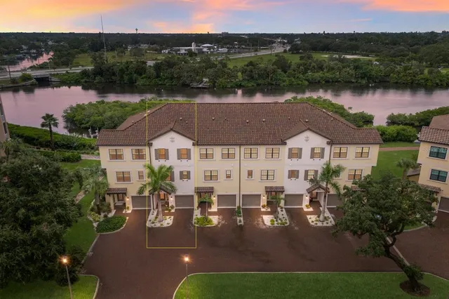 an aerial view of multiple houses with a lake view