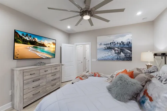 a bedroom with a bed a window and a chandelier