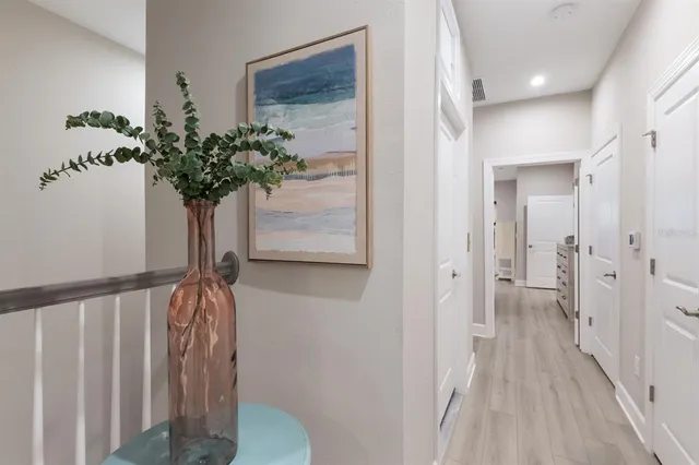 a view of an empty room with cabinet and window