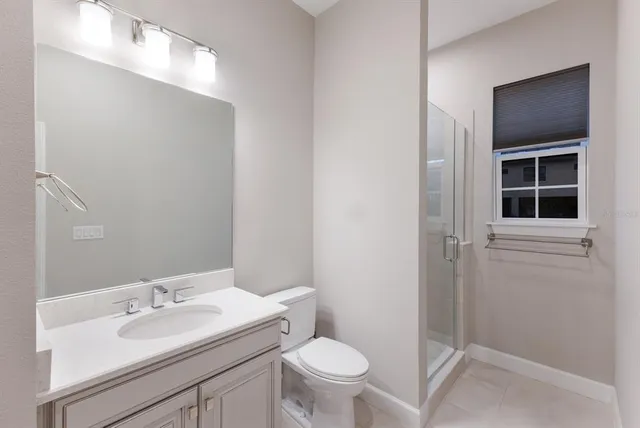 a view of a large white building with a yard