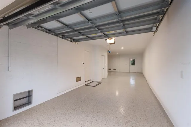 an aerial view of multiple houses with a lake view