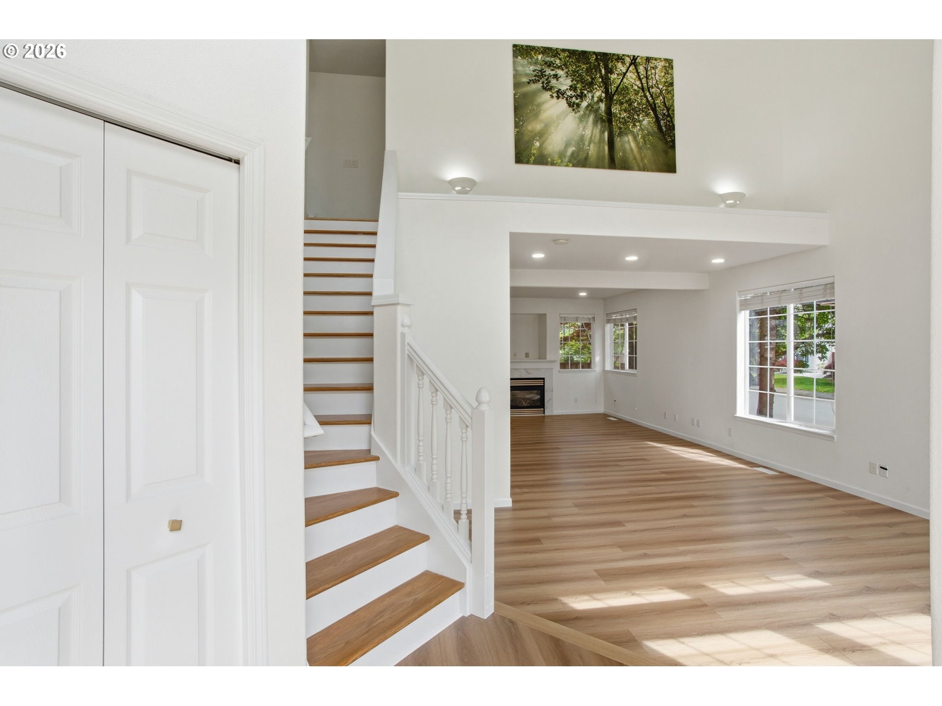 8911 Southwest Gravenstein Lane Tigard, OR 97224 - Photo 8 of 33 a view of a hallway with wooden floor and staircase