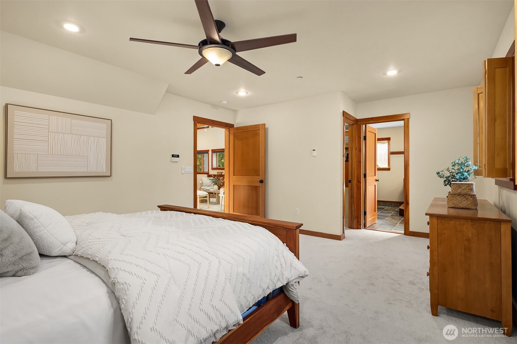 12317 176th Avenue Southeast Renton, WA 98059 - Photo 12 of 39 a spacious bedroom with a bed and a chandelier