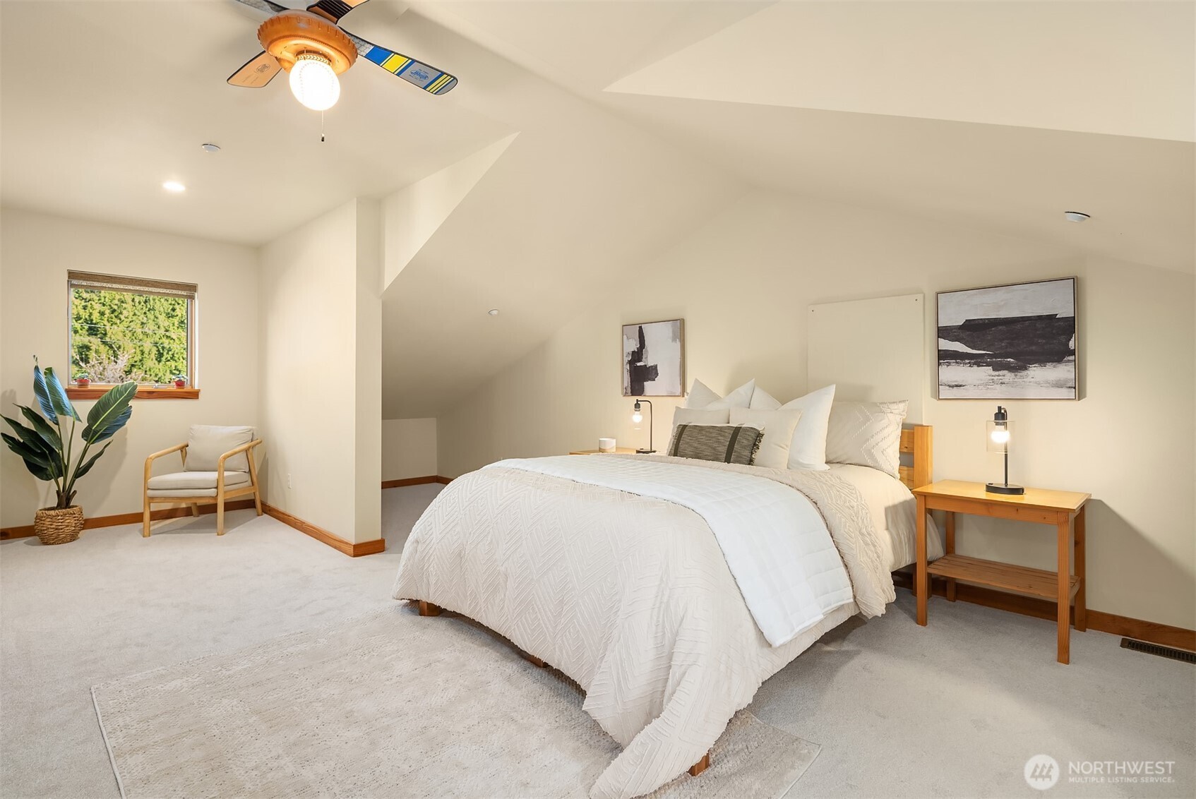 12317 176th Avenue Southeast Renton, WA 98059 - Photo 19 of 39 a bed room with a bed and a chandelier