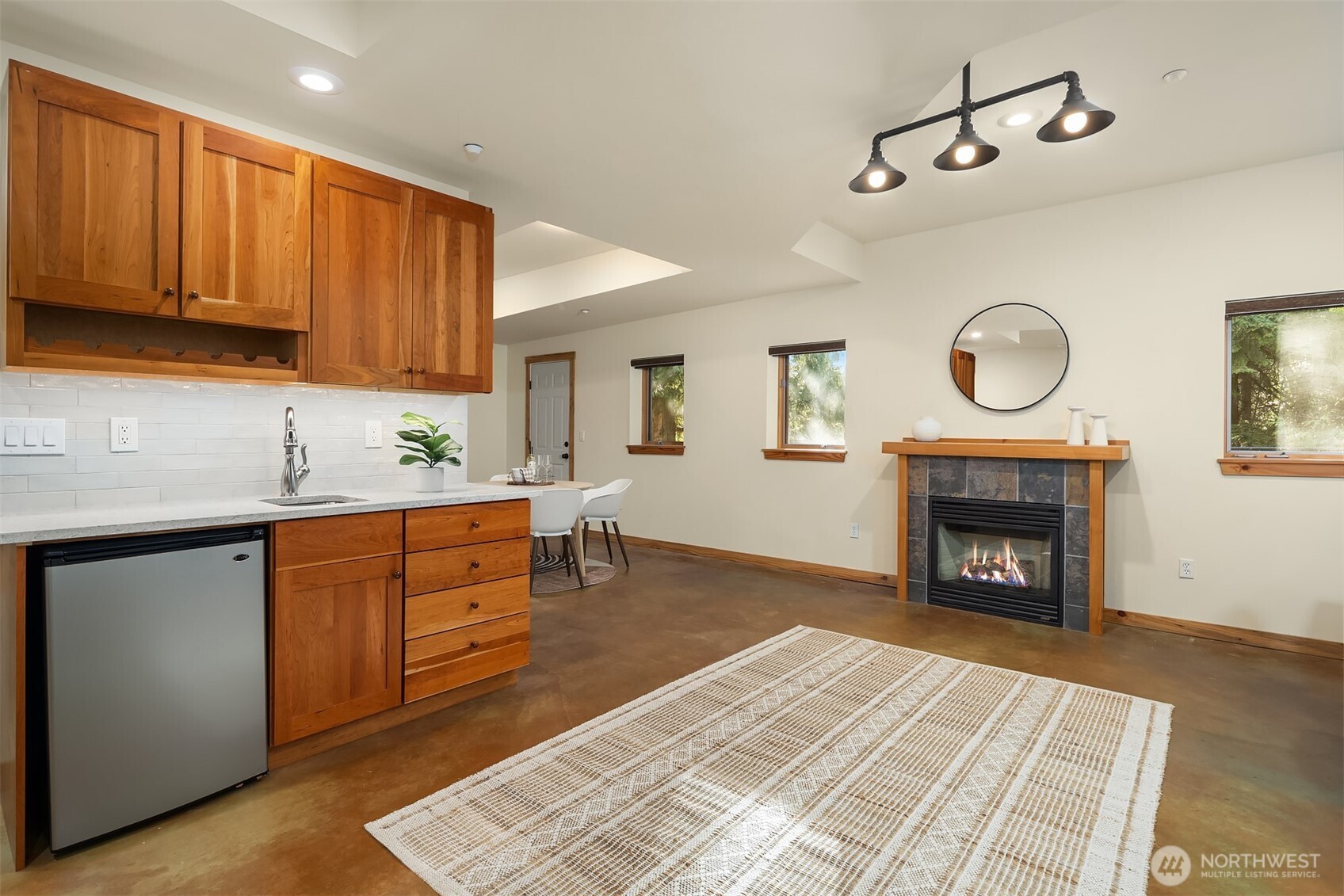 12317 176th Avenue Southeast Renton, WA 98059 - Photo 26 of 39 a kitchen with granite countertop a fireplace cabinets and a window