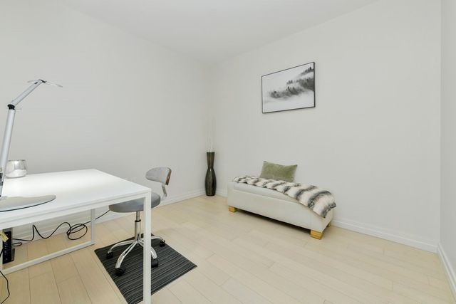 a living room with furniture and white walls