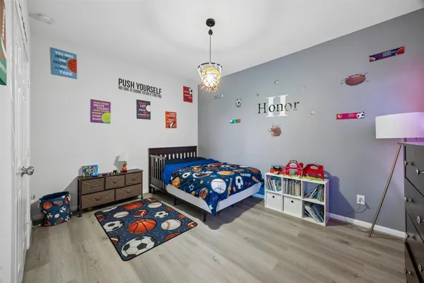 a bedroom with furniture and a wooden floor