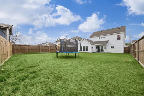 a view of a house with a big yard and a large tree