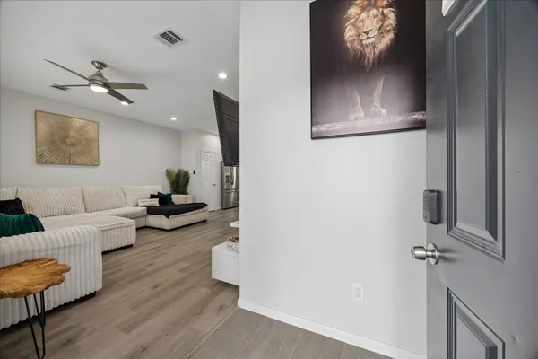 a living room with furniture and a wooden floor