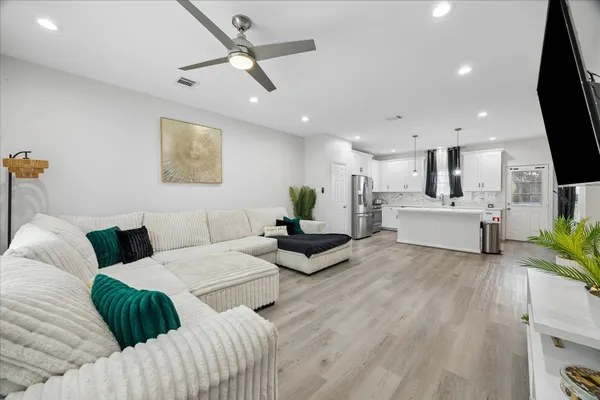 a living room with furniture and a flat screen tv
