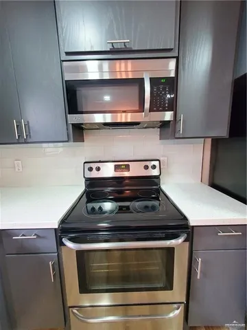 a stove top oven sitting inside of a kitchen