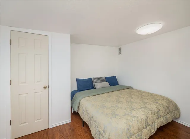 a bed sitting in a bedroom next to a bathroom