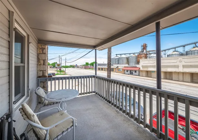 a view of a chairs and table in balcony