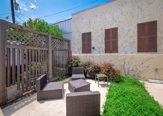 a view of a house with a small yard and furniture
