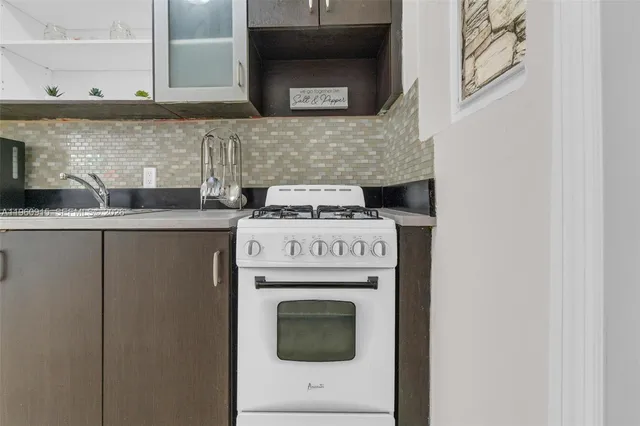 a kitchen with a stove and cabinets