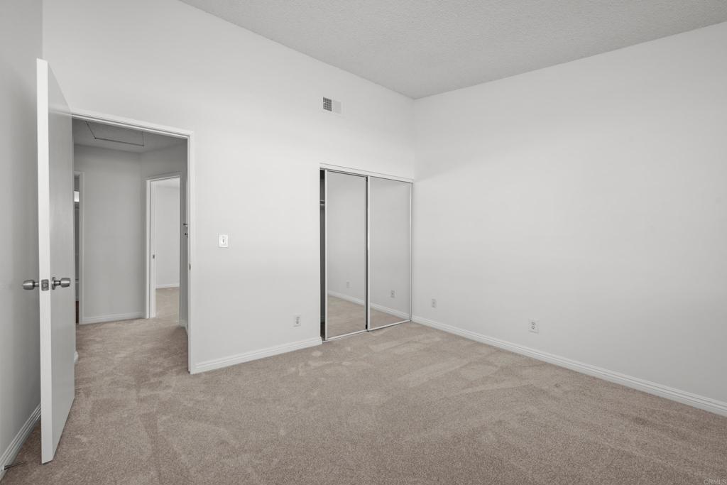 5120 North River Road, Unit E Oceanside, CA 92057 - Photo 11 of 13 an empty room with closet area