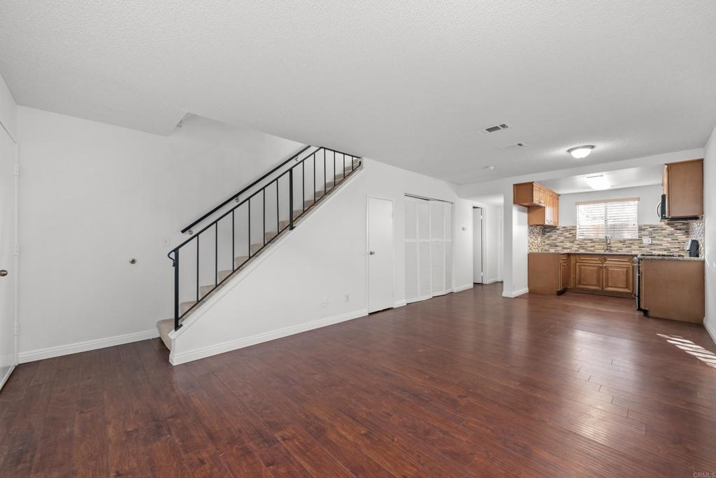 5120 North River Road, Unit E Oceanside, CA 92057 - Photo 4 of 13 a view of kitchen with wooden floor and electronic appliances