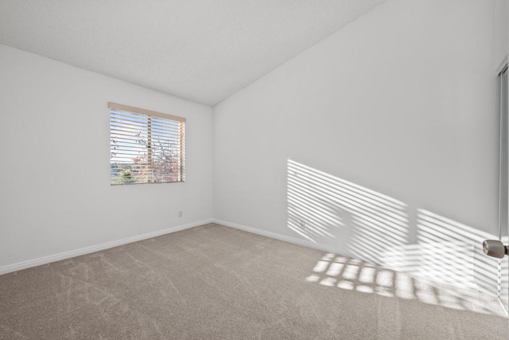 5120 North River Road, Unit E Oceanside, CA 92057 - Photo 8 of 13 an empty room with windows