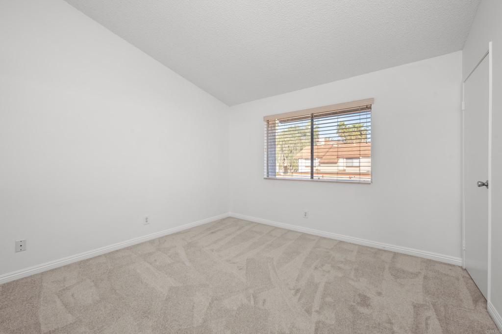 5120 North River Road, Unit E Oceanside, CA 92057 - Photo 10 of 13 an empty room with a window