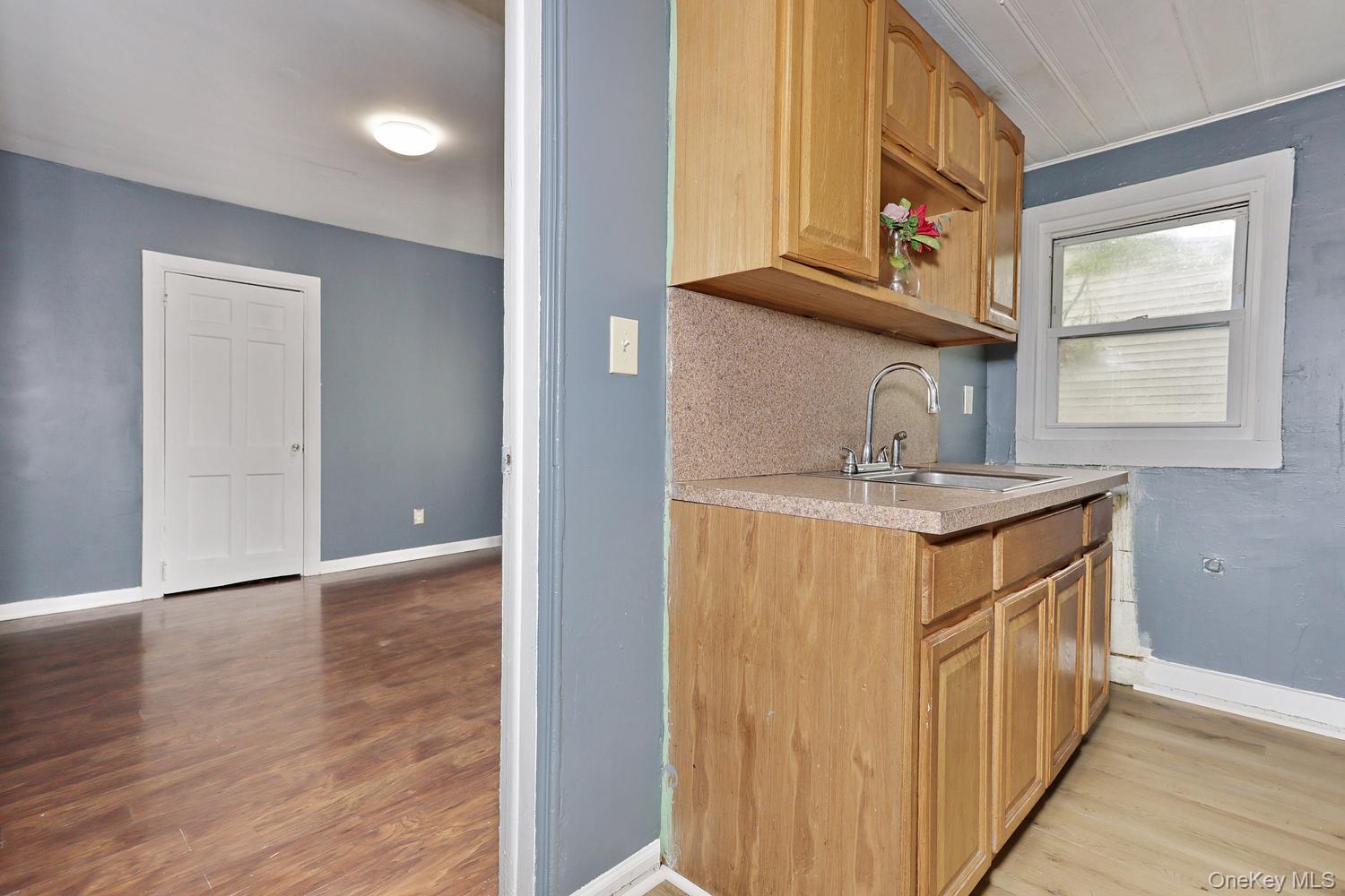 29 Fairview Avenue Spring Valley, NY 10977 - Photo 6 of 19 a hallway with stainless steel appliances granite countertop a sink and dishwasher with wooden floor