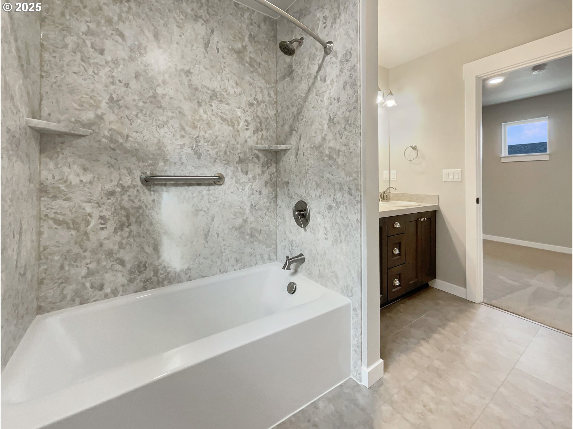 7127 South Ridge Way Ridgefield, WA 98642 - Photo 8 of 23 a bathroom with a bathtub and a shower