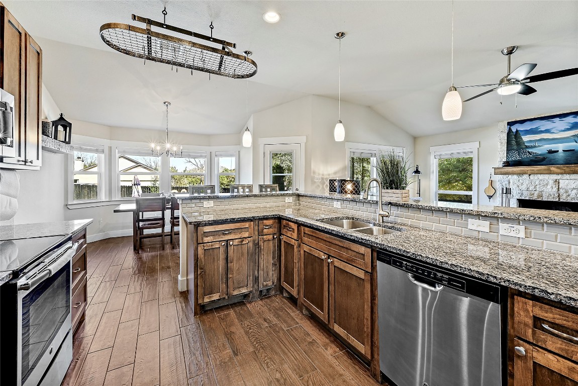 1 Rolling Hills Road Wimberley, TX 78676 - Photo 10 of 30 a kitchen with stainless steel appliances granite countertop a sink a stove and cabinets