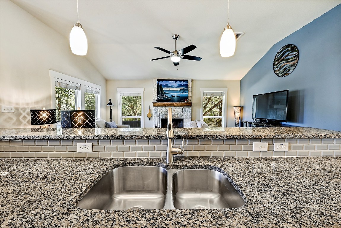 1 Rolling Hills Road Wimberley, TX 78676 - Photo 12 of 30 a kitchen with a sink a counter top space cabinets and stainless steel appliances