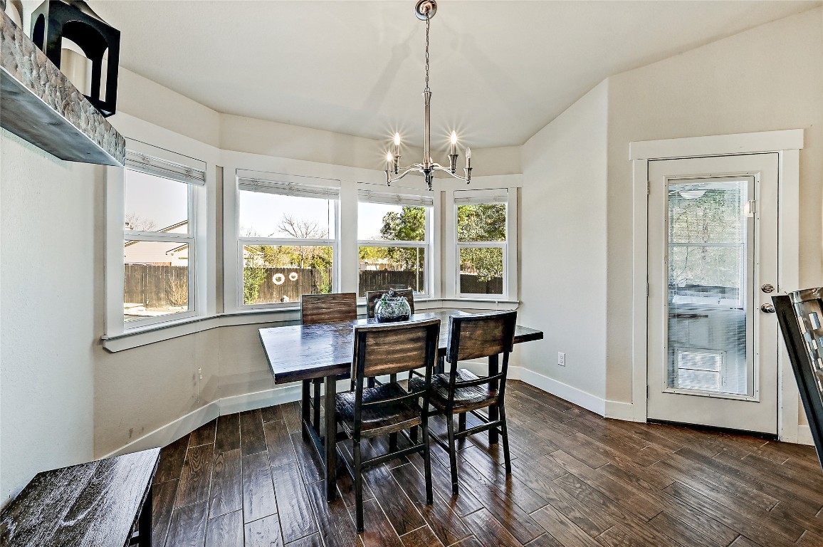1 Rolling Hills Road Wimberley, TX 78676 - Photo 13 of 30 a view of a dining room with furniture window and outside view