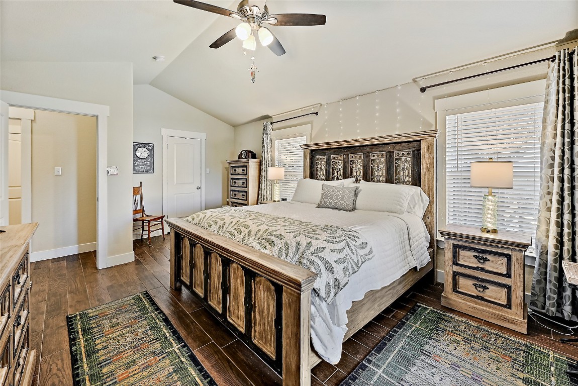 1 Rolling Hills Road Wimberley, TX 78676 - Photo 17 of 30 a bedroom with a bed and a chandelier