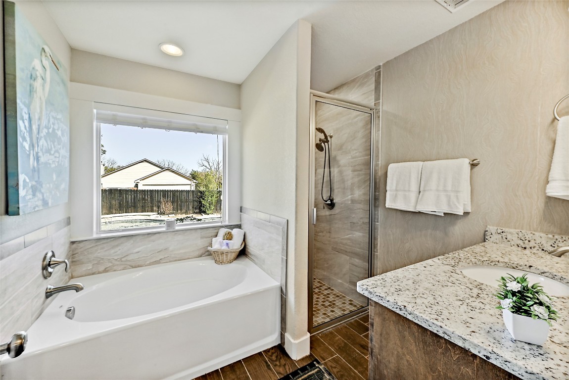 1 Rolling Hills Road Wimberley, TX 78676 - Photo 19 of 30 a bathroom with a tub a sink and a mirror