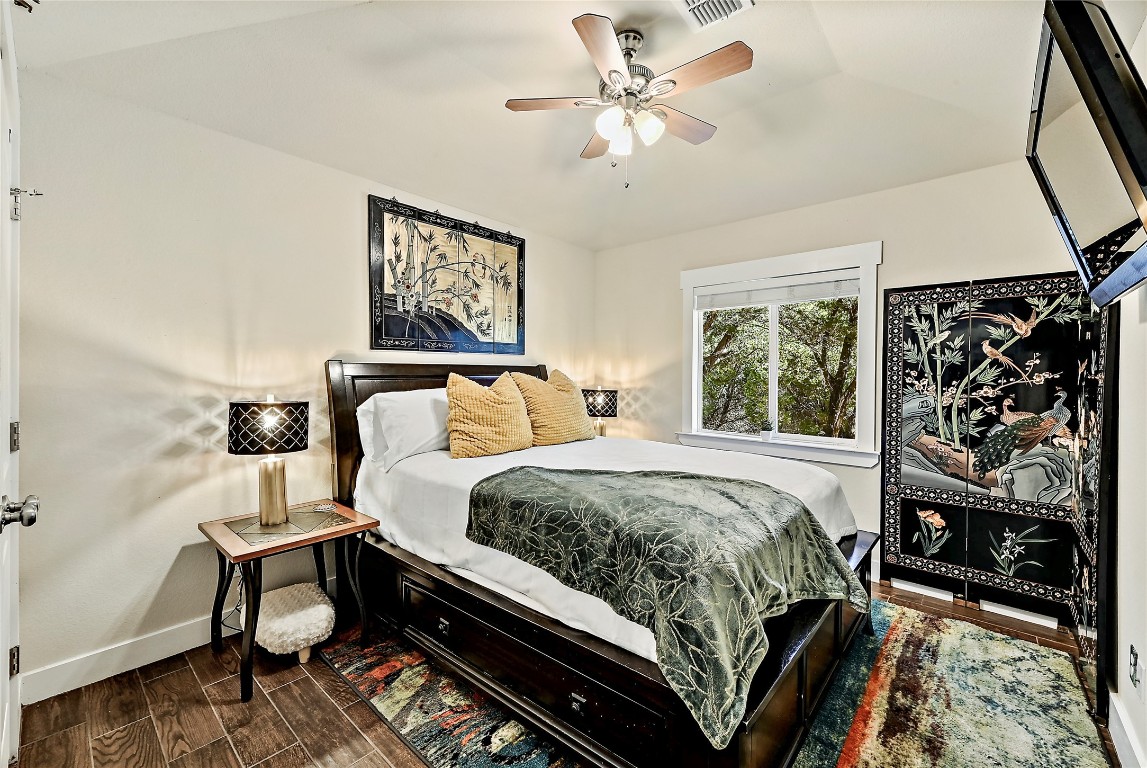 1 Rolling Hills Road Wimberley, TX 78676 - Photo 20 of 30 a bed sitting in a bedroom next to a window