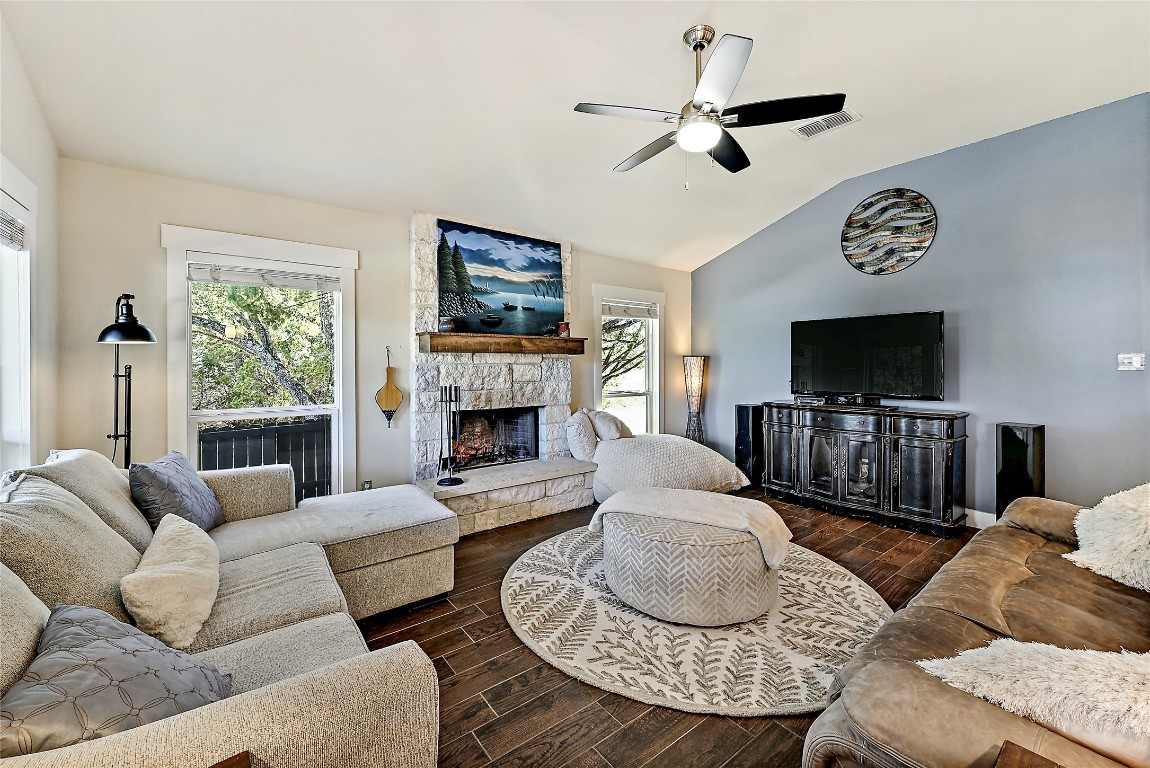 1 Rolling Hills Road Wimberley, TX 78676 - Photo 7 of 30 a living room with furniture a flat screen tv and a fireplace