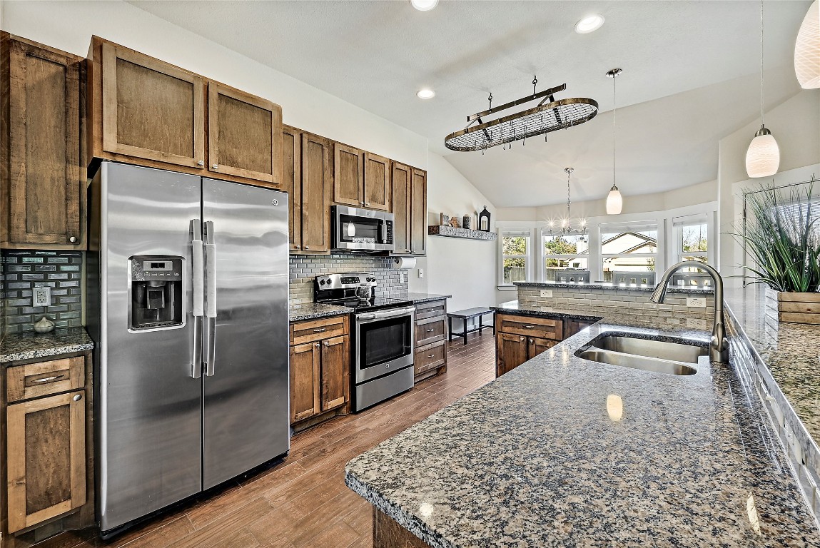 1 Rolling Hills Road Wimberley, TX 78676 - Photo 9 of 30 a kitchen with stainless steel appliances granite countertop a sink a stove and a refrigerator