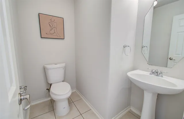 an empty room with chandelier fan and windows