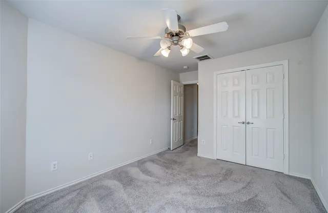 a view of a room with wooden floor and a garden