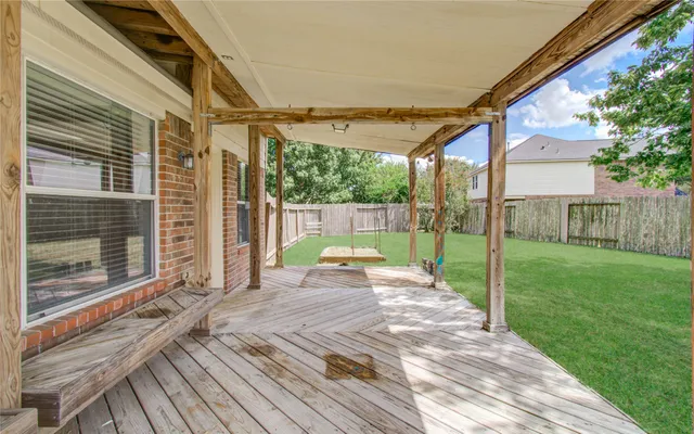 a view of a house with wooden fence