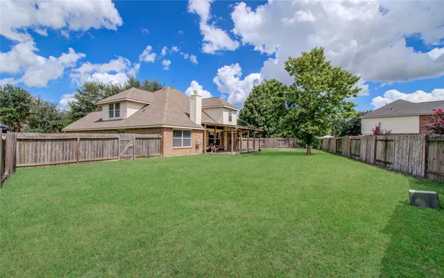 a view of a yard with a house in the background