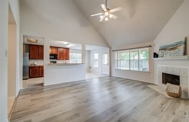 a view of a room with kitchen and fireplace wooden floor
