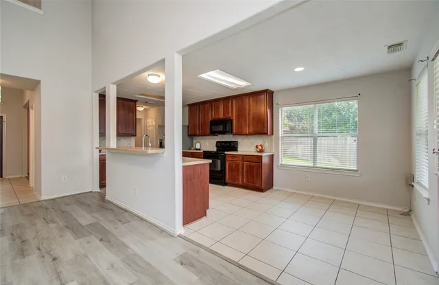 a kitchen with granite countertop a refrigerator and a sink