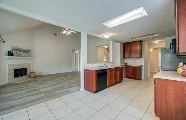 a large kitchen with a large counter top and stainless steel appliances