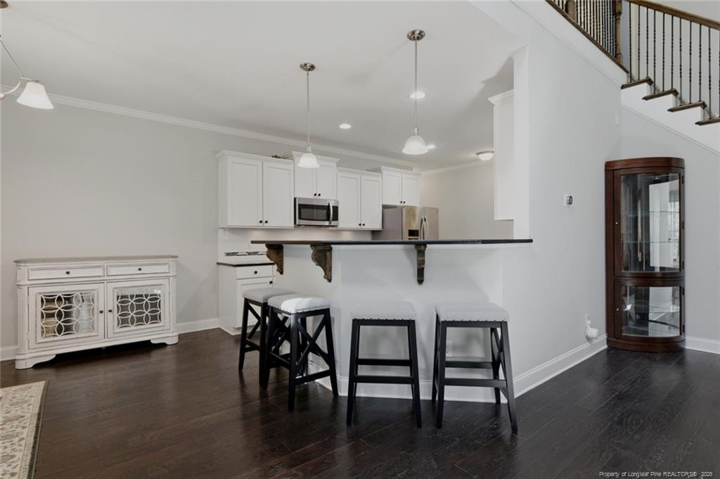 95 Valley Brook Lane Spring Lake, NC 28390 - Photo 13 of 49 a kitchen with stainless steel appliances granite countertop a refrigerator a stove top oven a dining table and chairs with wooden floor