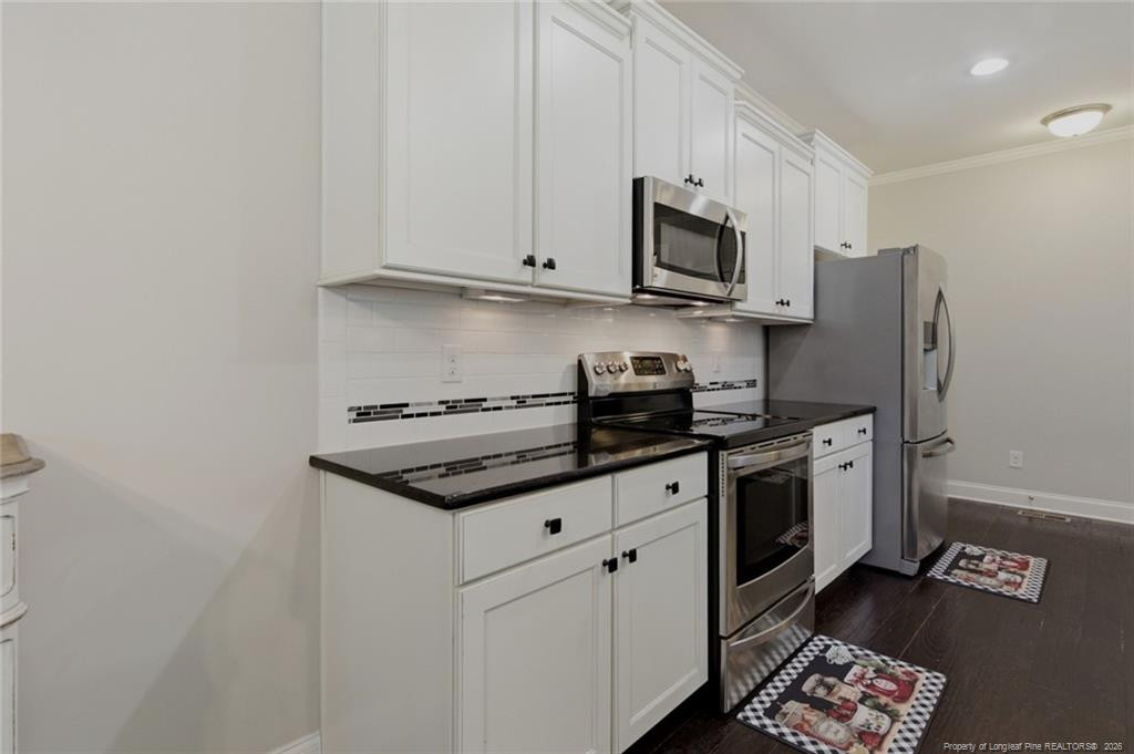 95 Valley Brook Lane Spring Lake, NC 28390 - Photo 15 of 49 a kitchen with stainless steel appliances granite countertop a stove a refrigerator and a microwave