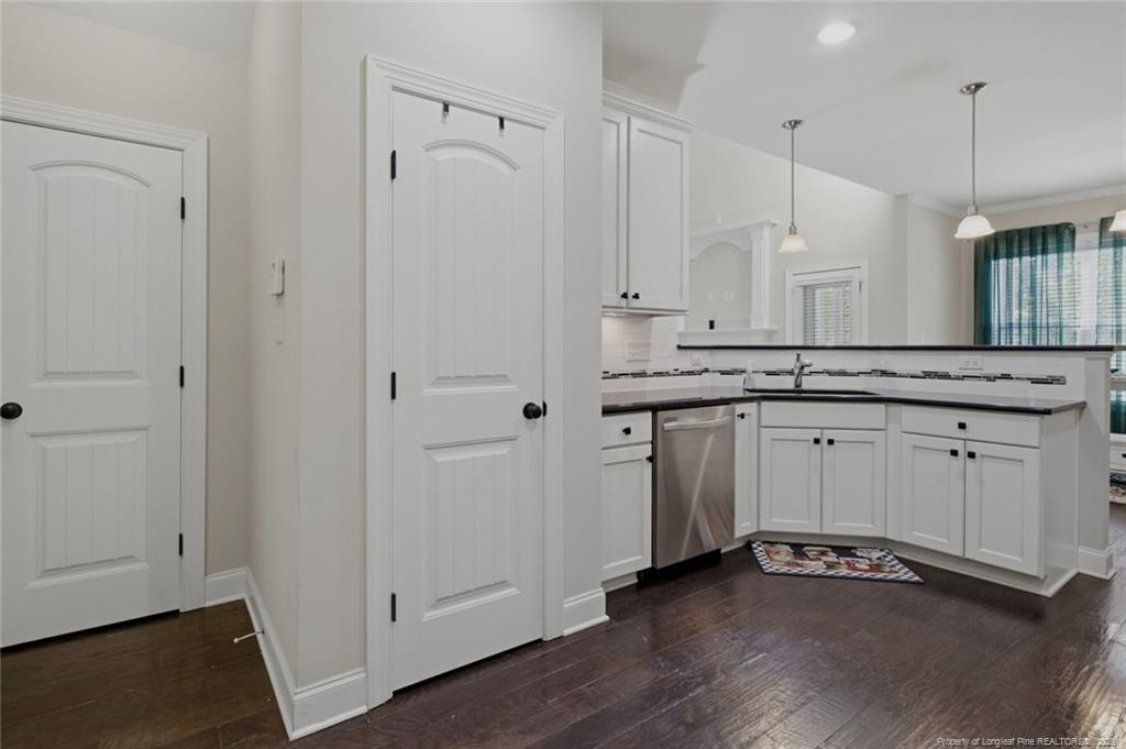 95 Valley Brook Lane Spring Lake, NC 28390 - Photo 16 of 49 a view of a kitchen with white cabinets and wooden floor