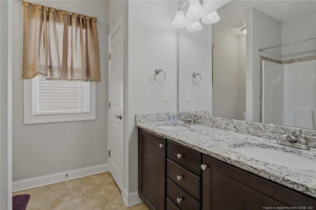95 Valley Brook Lane Spring Lake, NC 28390 - Photo 37 of 49 a bathroom with a granite countertop sink and a mirror