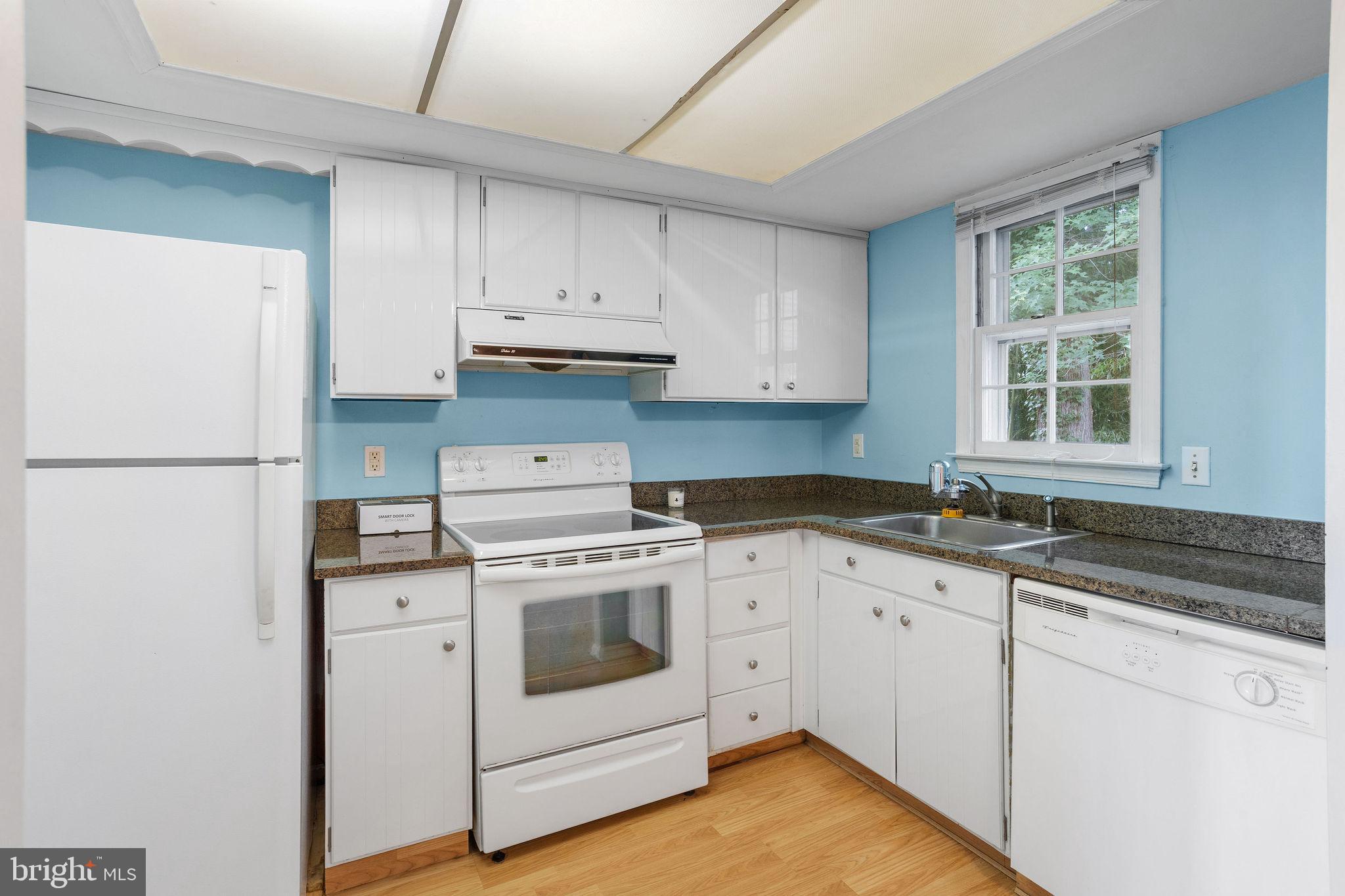 1610 Yardley Commons Yardley, PA 19067 - Photo 7 of 13 a kitchen with granite countertop white cabinets and white appliances