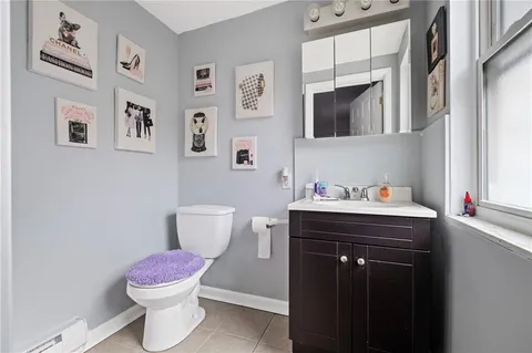 a bathroom with a toilet sink and mirror
