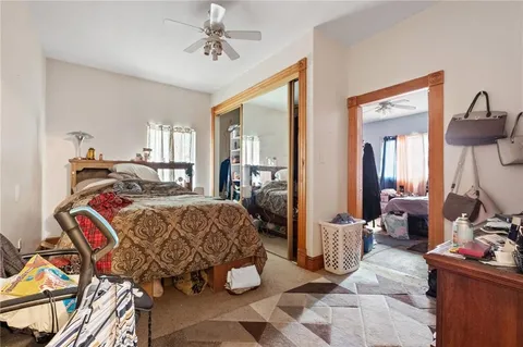 a bed room with a bed and a mirror