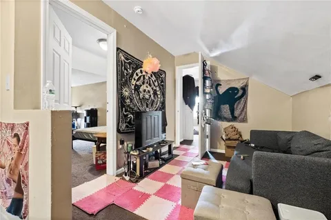 a living room with furniture and a floor to ceiling window
