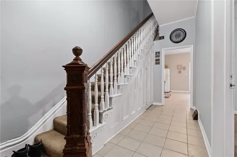 a view of a hallway with wooden floor and entryway